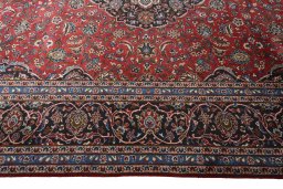 Corner detail of 2000s Kashan rug showing border pattern and Wool pile