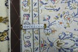Backside of handmade New Kashan rug showing knot structure and weave density