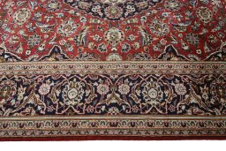 Corner detail of 2000s Kashan rug showing border pattern and Wool pile