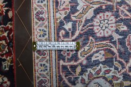 Backside of handmade 2000s Kashan rug showing knot structure and weave density