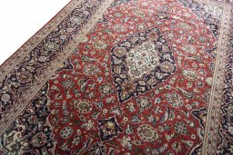 Backside of handmade 2000s Kashan rug showing knot structure and weave density