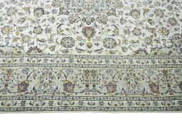 Corner detail of 2000s Kashan rug showing border pattern and Wool pile
