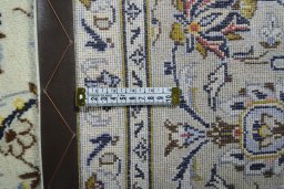 Backside of handmade 2000s Kashan rug showing knot structure and weave density