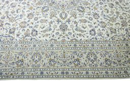 Corner detail of 2000s Kashan rug showing border pattern and Wool pile