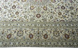Corner detail of 2000s Kashan rug showing border pattern and Wool pile
