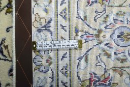 Backside of handmade 2000s Kashan rug showing knot structure and weave density