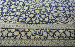 Corner detail of 2000s Kashan rug showing border pattern and Wool pile