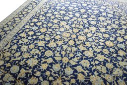 Backside of handmade 2000s Kashan rug showing knot structure and weave density