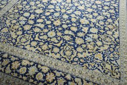 Close-up detail of 2000s Kashan rug from Iran / Persia showing Wool weave