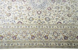 Corner detail of 2000s Kashan rug showing border pattern and Wool pile