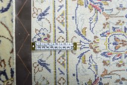 Backside of handmade 2000s Kashan rug showing knot structure and weave density