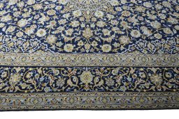 Corner detail of 2000s Kashan rug showing border pattern and Wool pile