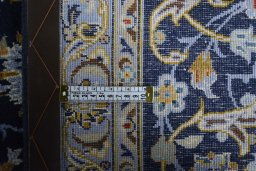 Backside of handmade 2000s Kashan rug showing knot structure and weave density
