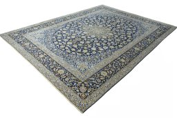 Corner detail of 2000s Kashan rug showing border pattern and Wool pile