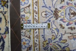 Backside of handmade 2000s Kashan rug showing knot structure and weave density