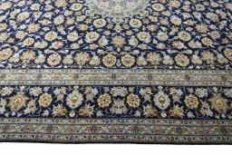 Corner detail of 2000s Kashan rug showing border pattern and Wool pile