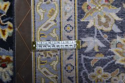 Backside of handmade 2000s Kashan rug showing knot structure and weave density