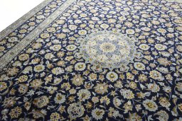 Backside of handmade 2000s Kashan rug showing knot structure and weave density