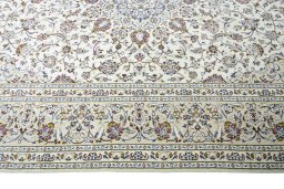 Corner detail of 2000s Kashan rug showing border pattern and Wool pile