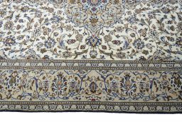 Corner detail of 2000s Kashan rug showing border pattern and Wool pile