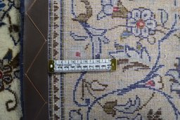 Backside of handmade 2000s Kashan rug showing knot structure and weave density