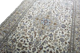 Backside of handmade 2000s Kashan rug showing knot structure and weave density