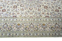 Corner detail of 2000s Kashan rug showing border pattern and Wool pile