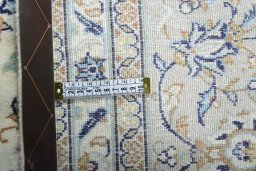 Backside of handmade New Kashan rug showing knot structure and weave density