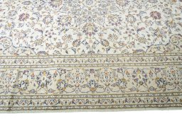 Corner detail of 2000s Kashan rug showing border pattern and Wool pile