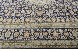 Corner detail of 2000s Kashan rug showing border pattern and Wool pile