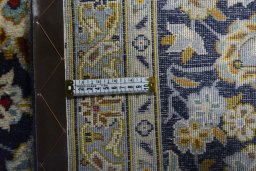 Backside of handmade 2000s Kashan rug showing knot structure and weave density