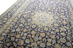 Backside of handmade 2000s Kashan rug showing knot structure and weave density