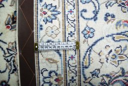 Backside of handmade 2000s Kashan rug showing knot structure and weave density