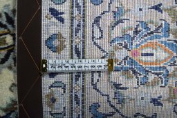 Backside of handmade New Kashan rug showing knot structure and weave density