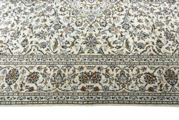 Corner detail of 2000s Kashan rug showing border pattern and Wool pile