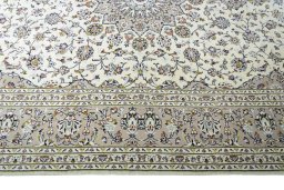 Corner detail of 2000s Kashan rug showing border pattern and Wool pile