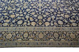 Corner detail of 2000s Kashan rug showing border pattern and Wool pile