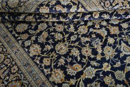 Close-up detail of 2000s Kashan rug from Iran / Persia showing Wool weave