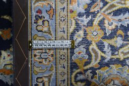 Backside of handmade 2000s Kashan rug showing knot structure and weave density