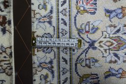 Backside of handmade 2000s Kashan rug showing knot structure and weave density