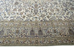 Corner detail of 2000s Kashan rug showing border pattern and Wool pile