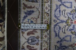Backside of handmade 2000s Kashan rug showing knot structure and weave density