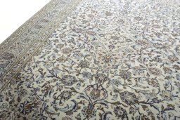 Backside of handmade 2000s Kashan rug showing knot structure and weave density