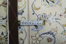 Backside of handmade New Kashan rug showing knot structure and weave density