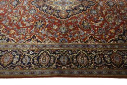 Corner detail of 2000s Kashan rug showing border pattern and Cork pile