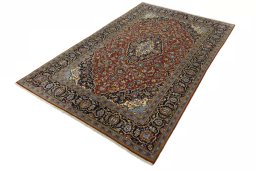 Corner detail of 2000s Kashan rug showing border pattern and Cork pile