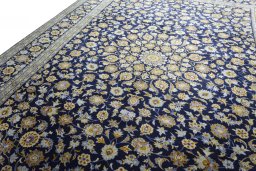 Backside of handmade 2000s Kashan rug showing knot structure and weave density