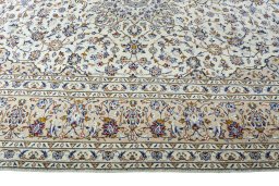 Corner detail of 2000s Kashan rug showing border pattern and Wool pile