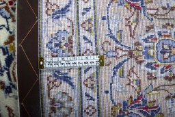 Backside of handmade 2000s Kashan rug showing knot structure and weave density