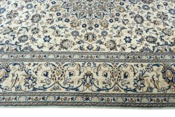 Corner detail of 2000s Kashan rug showing border pattern and Wool pile